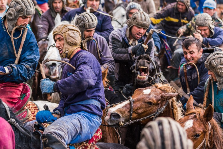 Photojournalism - Buzkashi riders in a fierce battle. Tajikistan, Central Asia